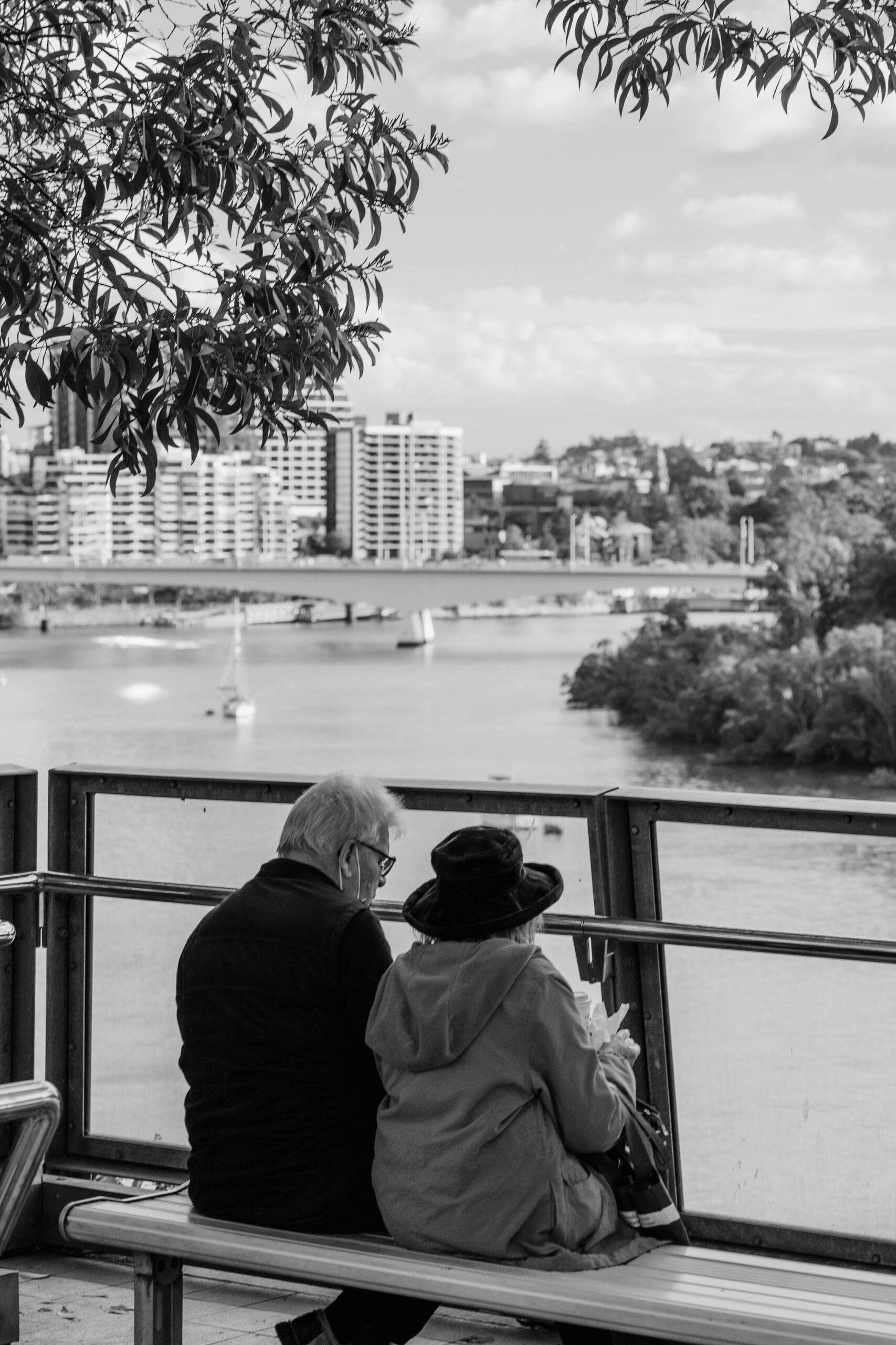 Two senior citizens sitting on a park bench
